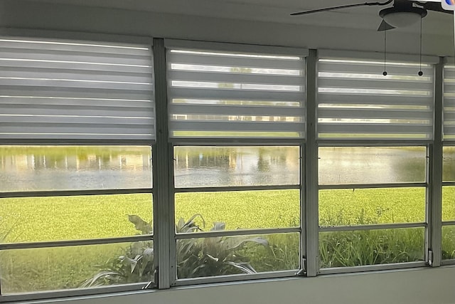 interior space featuring ceiling fan and a water view