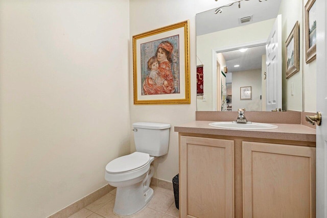 bathroom with vanity, tile patterned floors, and toilet