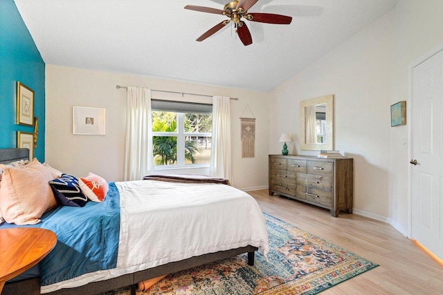 bedroom featuring ceiling fan, lofted ceiling, and light wood-type flooring