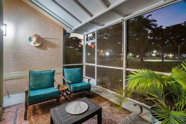 sunroom / solarium featuring vaulted ceiling