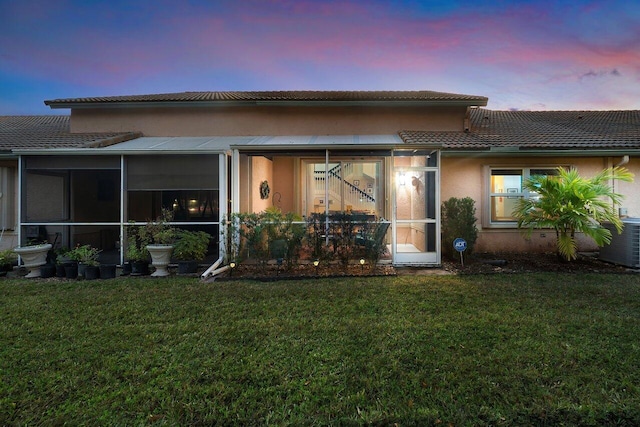 exterior space with a lawn and a sunroom