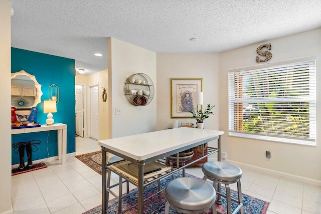 tiled dining room with a textured ceiling