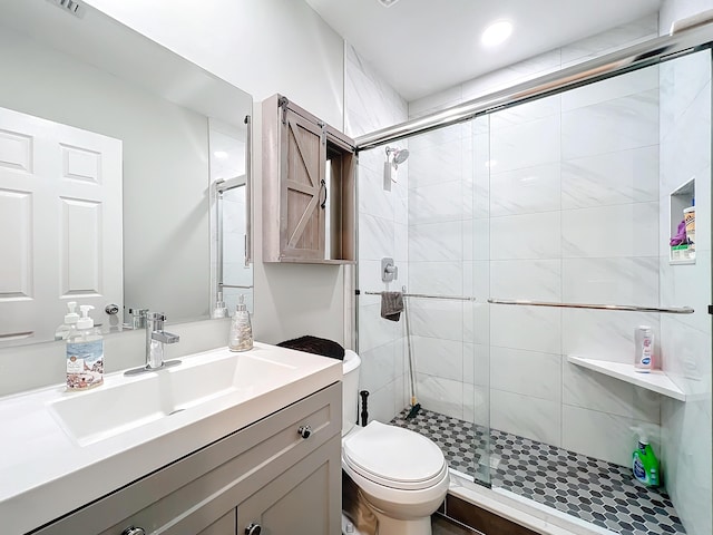 bathroom featuring walk in shower, vanity, and toilet