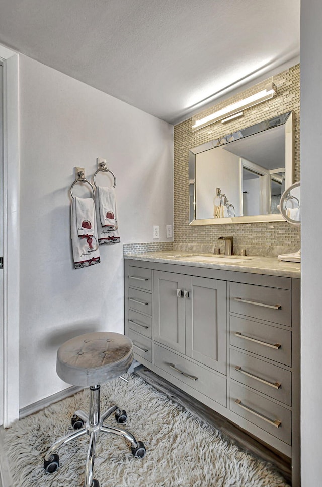 bathroom with vanity and decorative backsplash