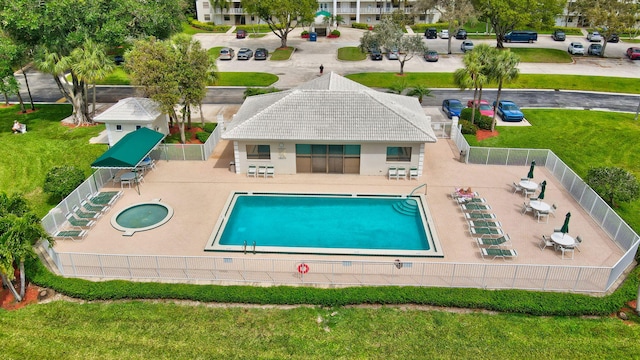 view of pool with a hot tub and a patio area