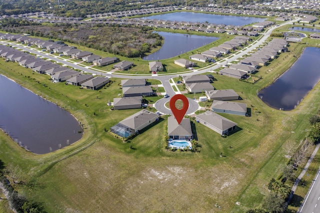 birds eye view of property featuring a water view and a residential view