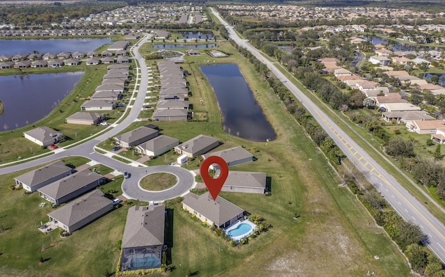 drone / aerial view featuring a water view and a residential view