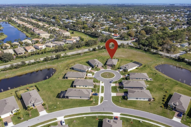 bird's eye view featuring a water view and a residential view