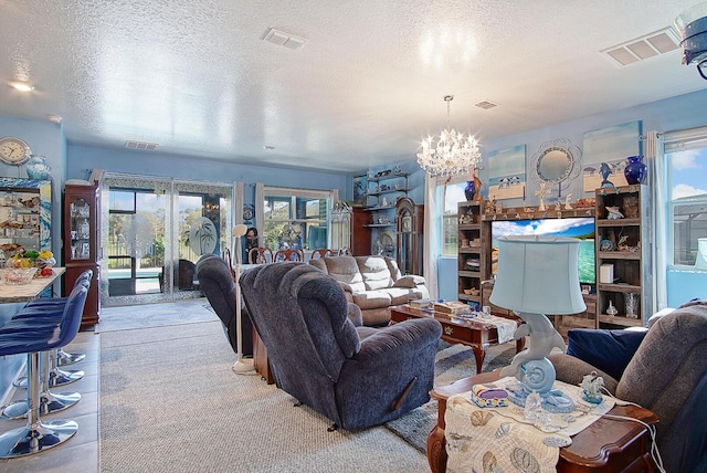 living room featuring a textured ceiling and a chandelier