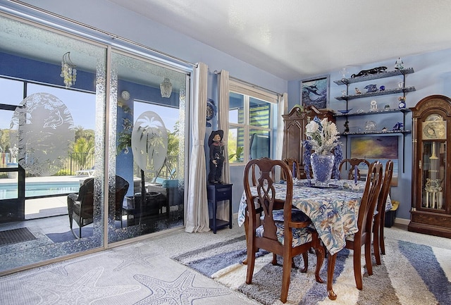 dining area with carpet and baseboards