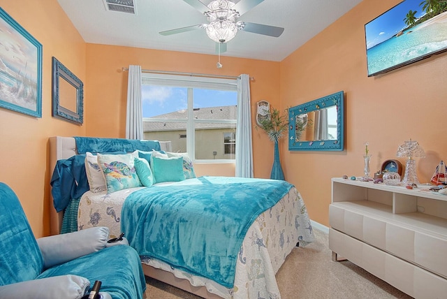 bedroom with baseboards, carpet, visible vents, and a ceiling fan