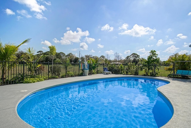 view of swimming pool featuring a fenced in pool and fence