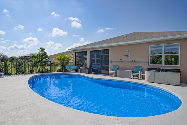 view of swimming pool featuring a patio and a sunroom