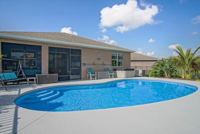 view of pool with central AC unit and a patio area