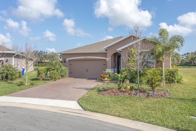 view of front of house featuring a garage and a front lawn