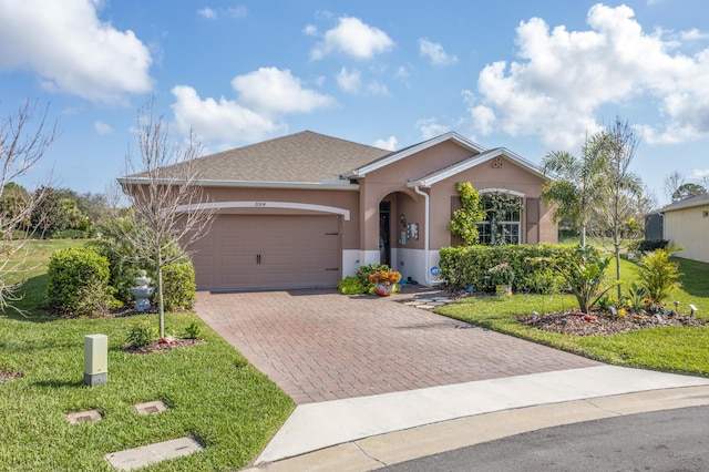 single story home featuring a garage and a front yard