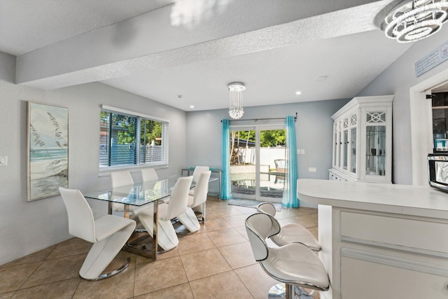 dining room featuring a textured ceiling and light tile patterned floors