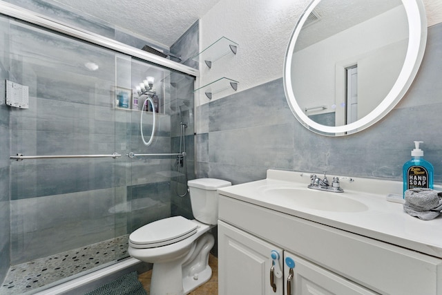 bathroom featuring vanity, walk in shower, a textured ceiling, and toilet