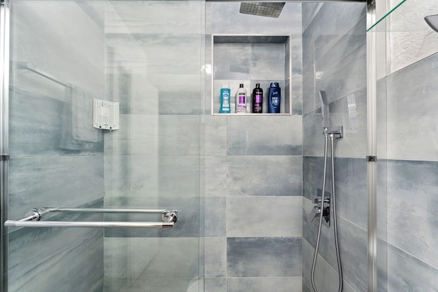 bathroom featuring a shower with shower door