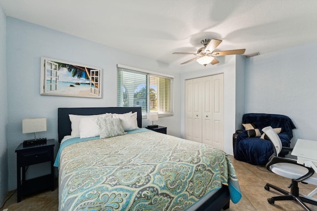 bedroom with light tile patterned flooring, ceiling fan, and a closet