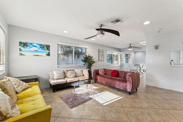 living room featuring light tile patterned floors and ceiling fan