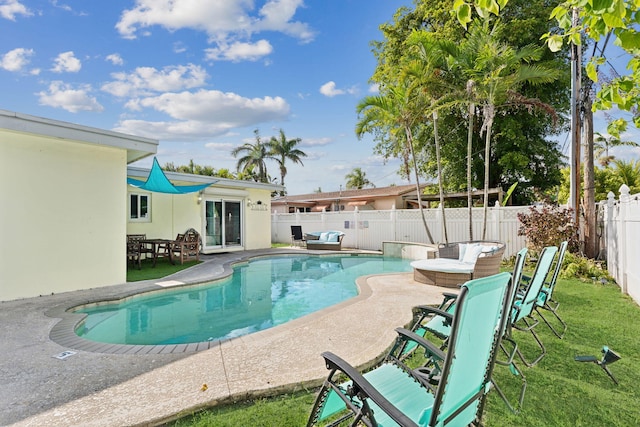 view of swimming pool with a yard and a patio