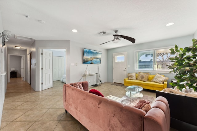 tiled living room featuring ceiling fan