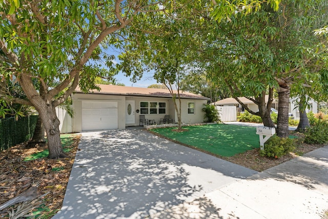 view of front of property featuring a garage and a front lawn