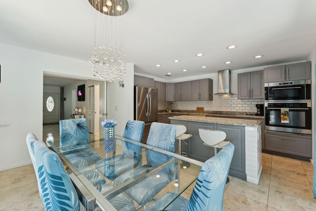 tiled dining space with sink and a notable chandelier