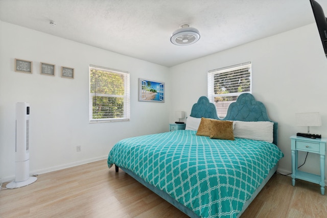 bedroom with hardwood / wood-style flooring