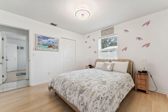 bedroom featuring a closet and light wood-type flooring