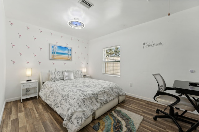 bedroom with dark hardwood / wood-style flooring