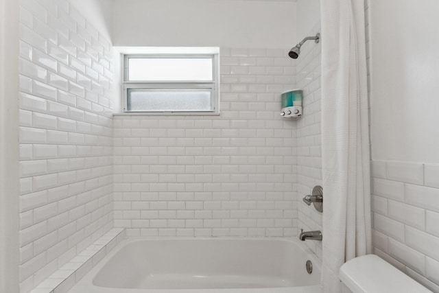 bathroom with shower / tub combo with curtain, toilet, and tile walls