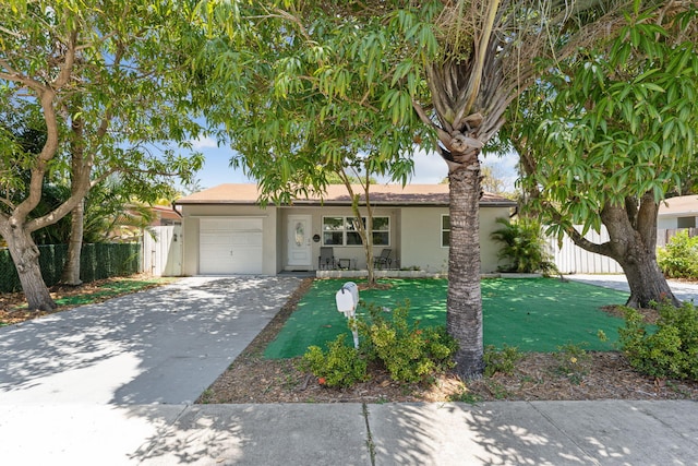 view of front of property with a garage and a front yard