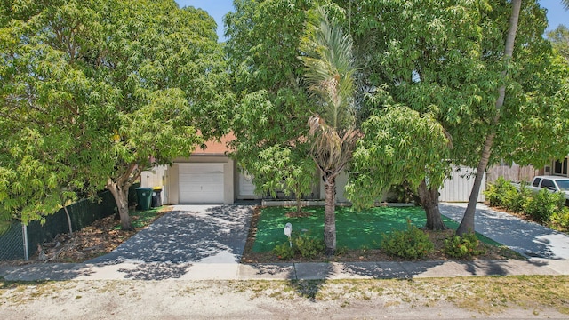 obstructed view of property with a garage