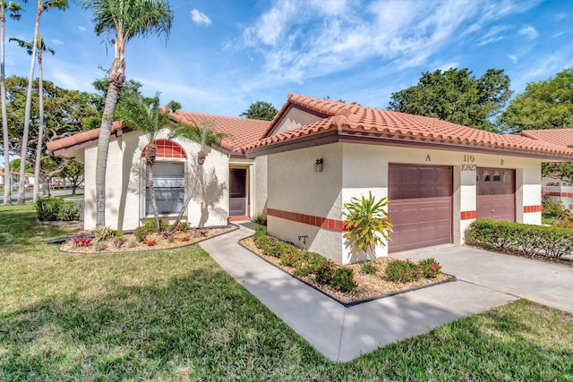 mediterranean / spanish house featuring a garage and a front yard