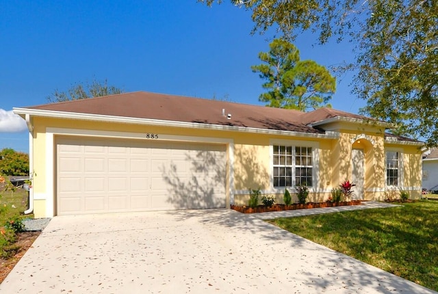 view of front of house with a garage and a front lawn