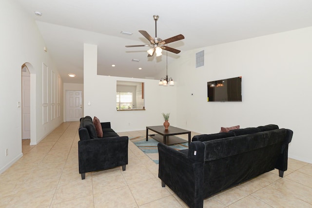 tiled living room featuring ceiling fan and vaulted ceiling