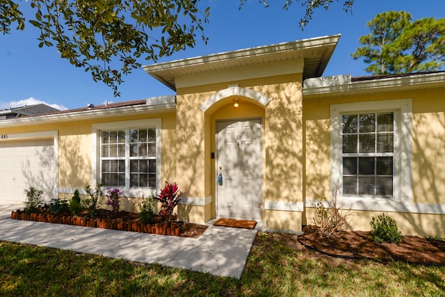 view of exterior entry featuring a garage