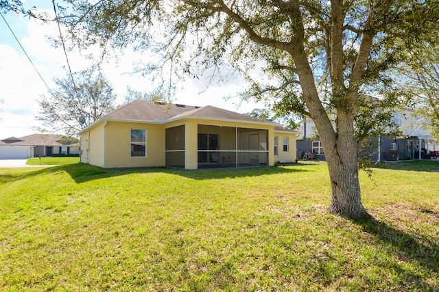 back of property featuring a lawn