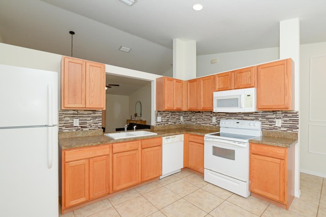 kitchen with sink, white appliances, vaulted ceiling, and light tile patterned floors