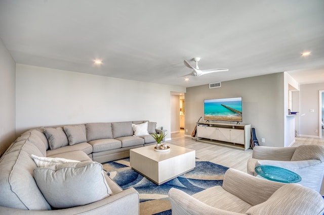 living room featuring ceiling fan and light wood-type flooring