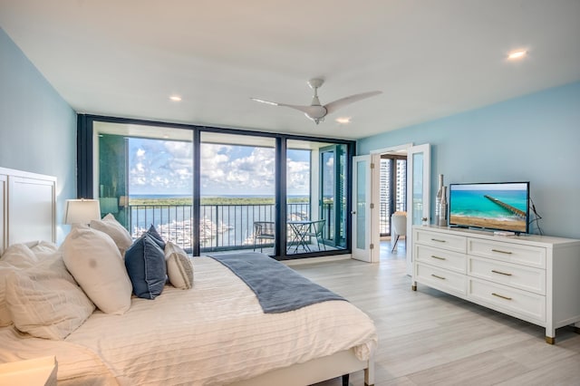 bedroom with floor to ceiling windows, access to outside, ceiling fan, and light wood-type flooring