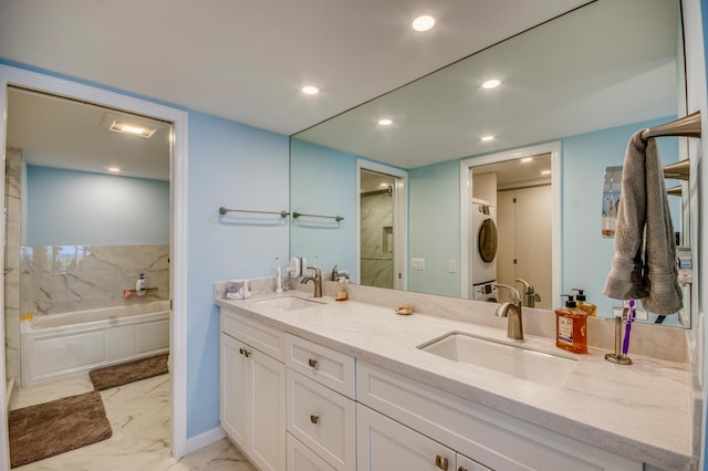 bathroom with vanity, stacked washer and dryer, and shower / bathtub combination