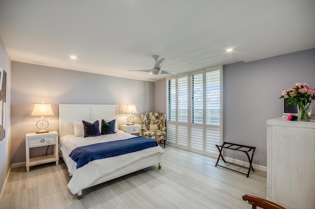 bedroom with ceiling fan and a wall of windows