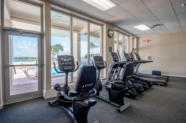 exercise room with a paneled ceiling