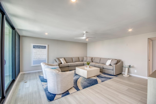 living room featuring light hardwood / wood-style flooring and ceiling fan