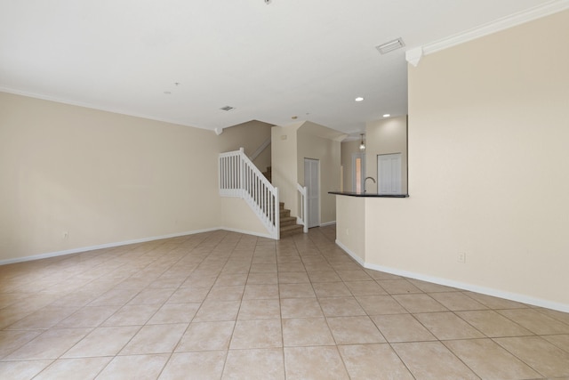 tiled empty room with crown molding and sink