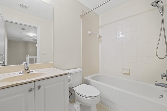 full bathroom with tile patterned floors, vanity, toilet, and tiled shower / bath combo