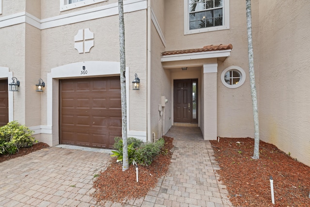 view of exterior entry featuring a garage